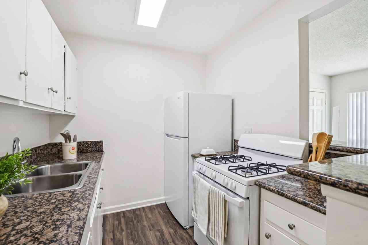 modern galley kitchen with granite style counters