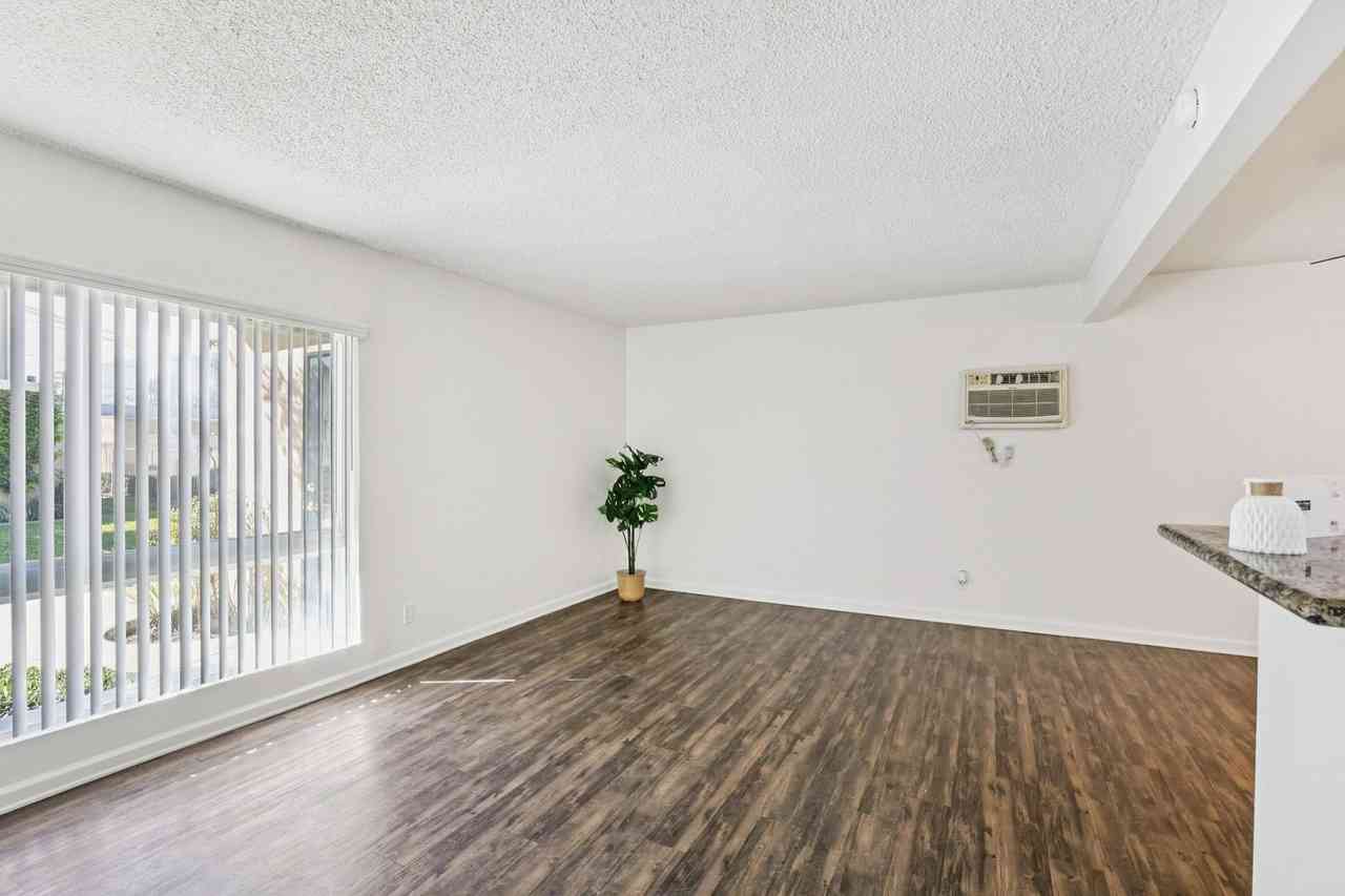 spacious living area with hardwood style flooring