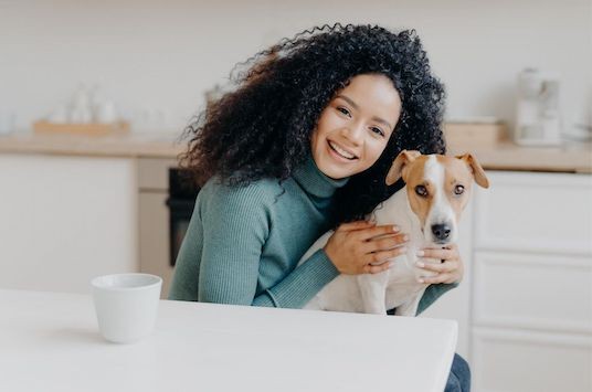 Woman holding her puppy at Dresden Place Apartments